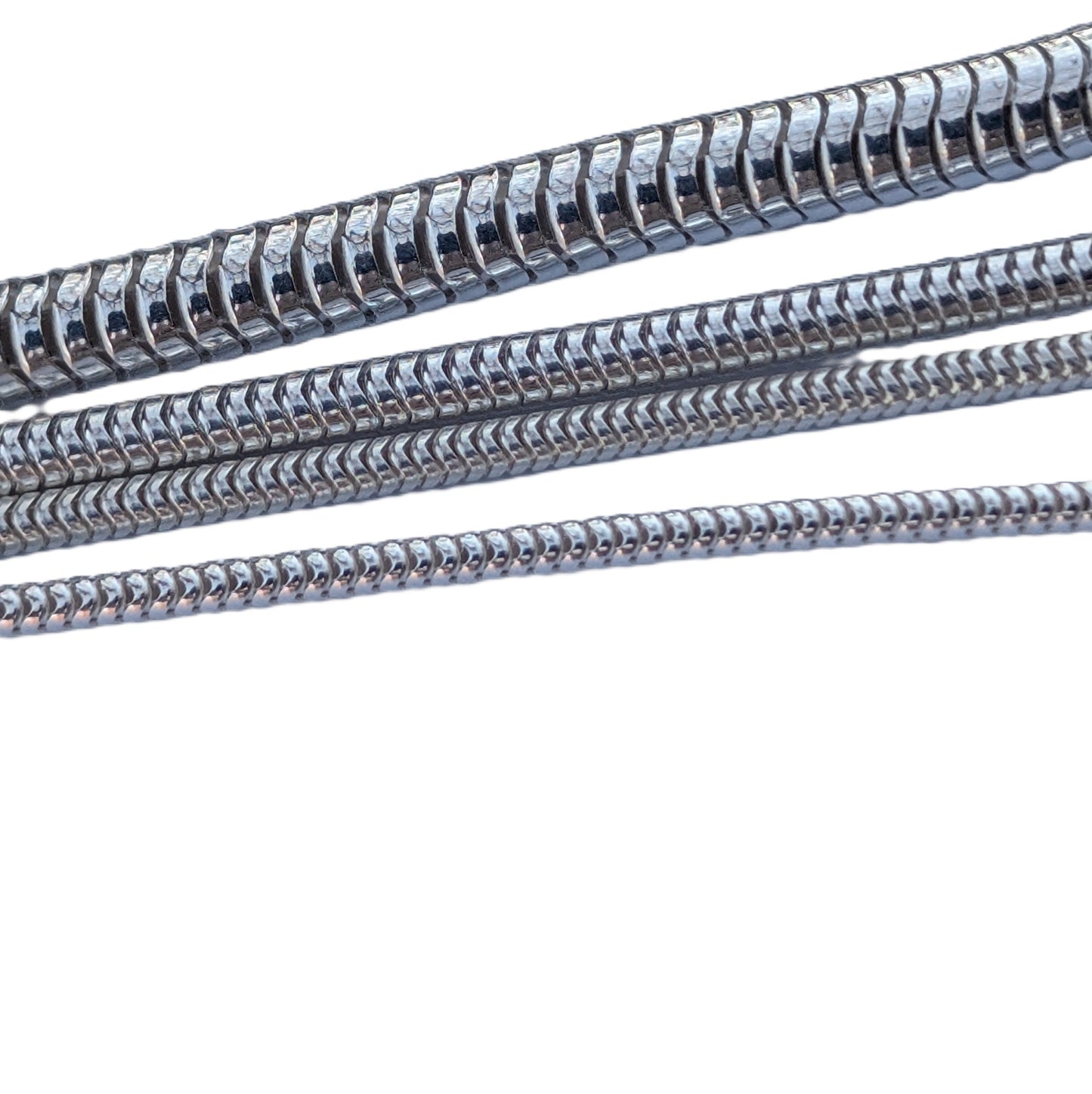 Metallic coiled hose on a white background