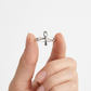 High-polish sterling silver Ankh ring held between fingers.