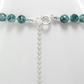 Close-up of the sterling silver spring-ring clasp and extension chain with green candy jade beads.