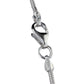 Close-up of a silver snake chain necklace on a white background